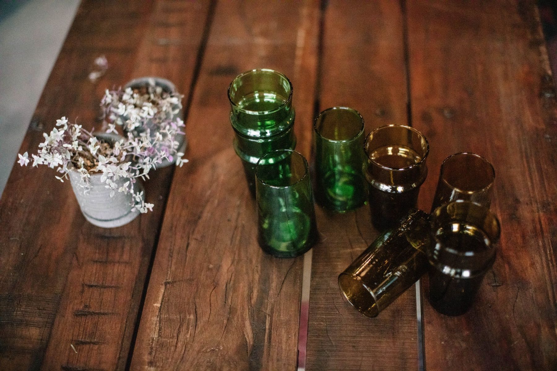Green and amber glassware on a wooden table