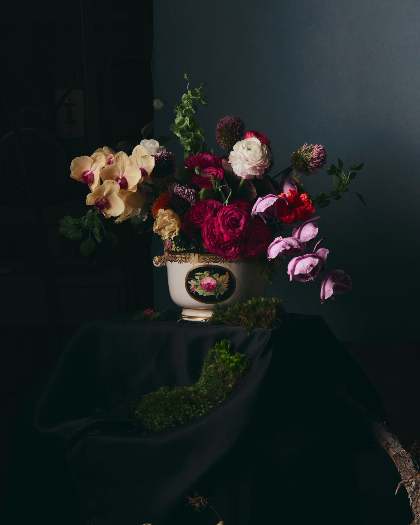Garden roses and orchids in a painted porcelain bowl