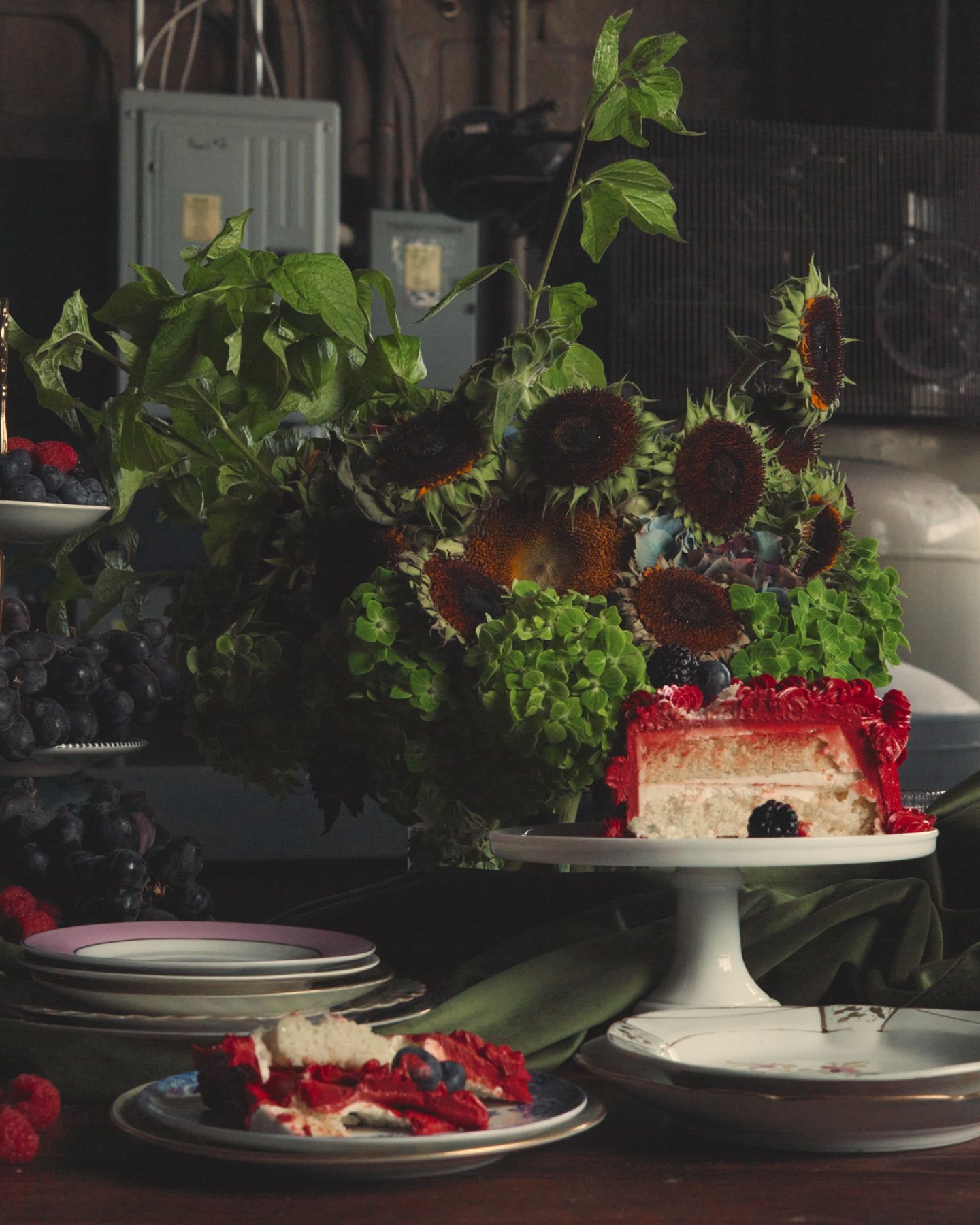 Sunflowers and greenery above a cut cake